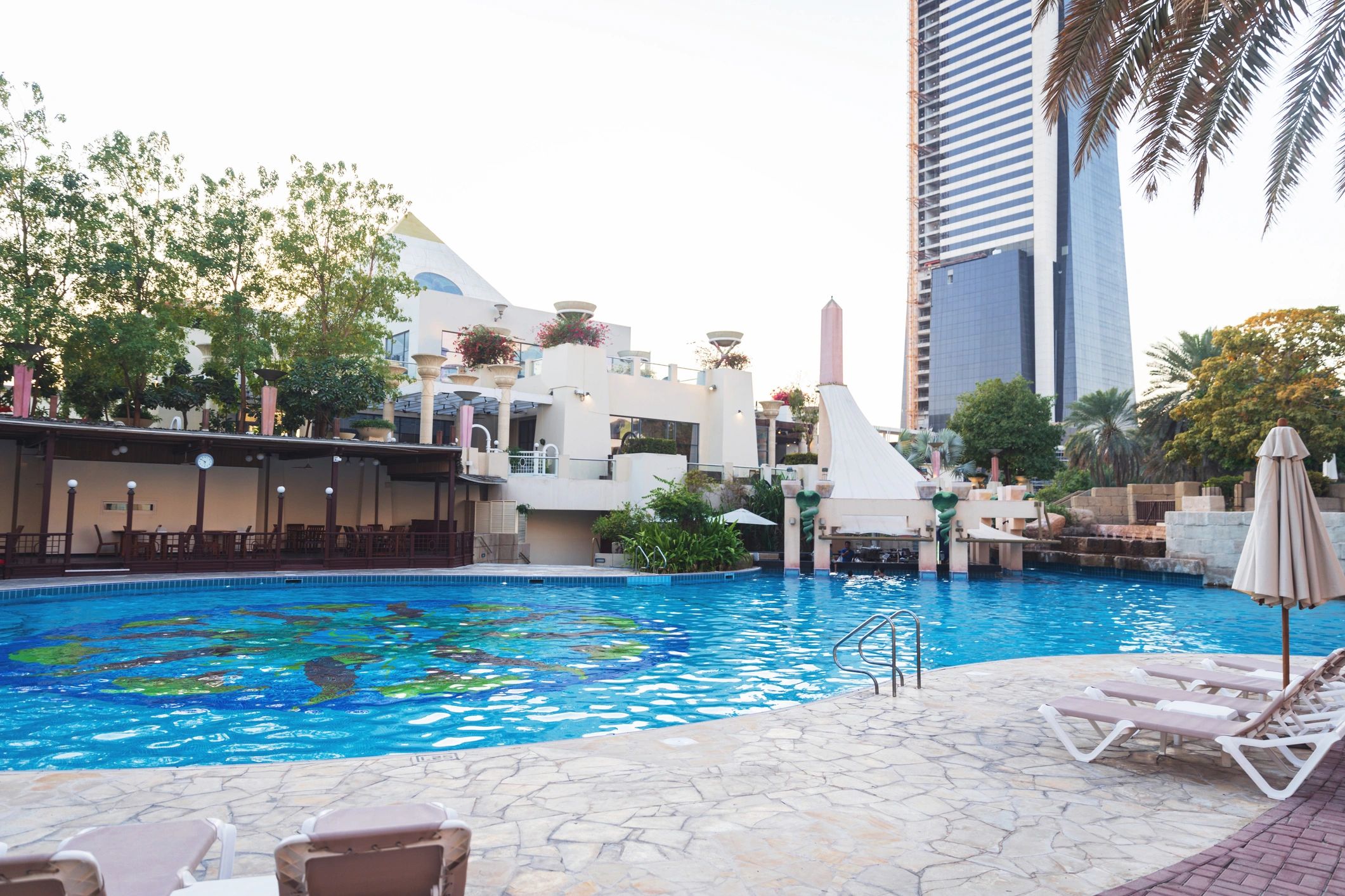 Luxury resort poolside with modern hospitality buildings