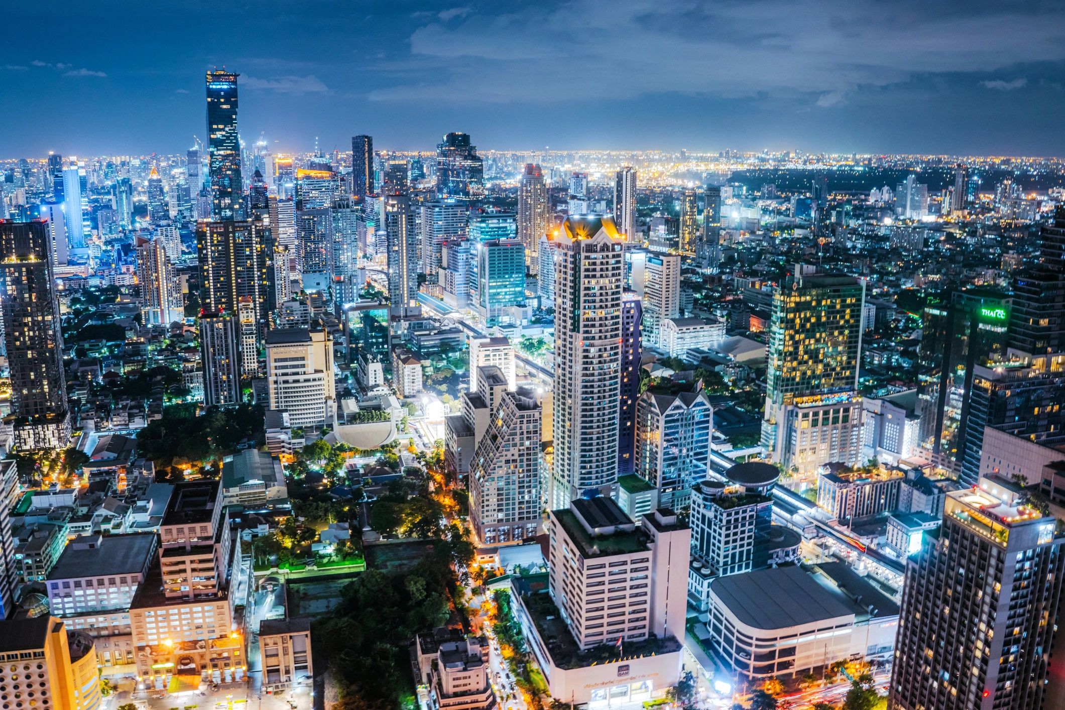 Modern city skyline at night representing hospitality destinations