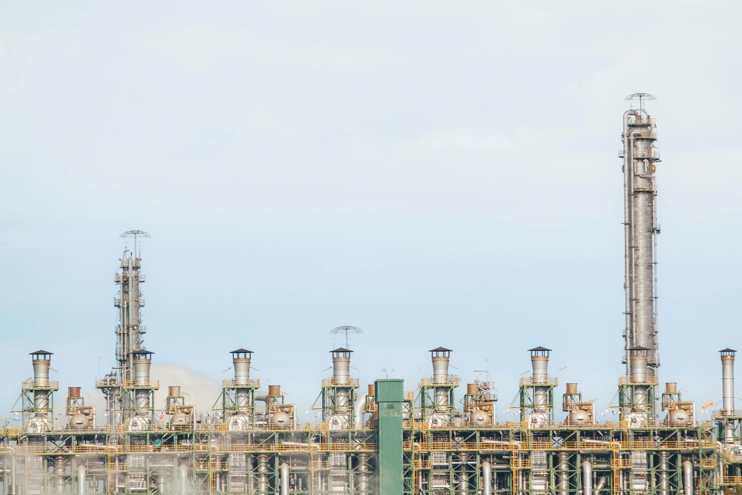Industrial facility with processing towers under blue sky