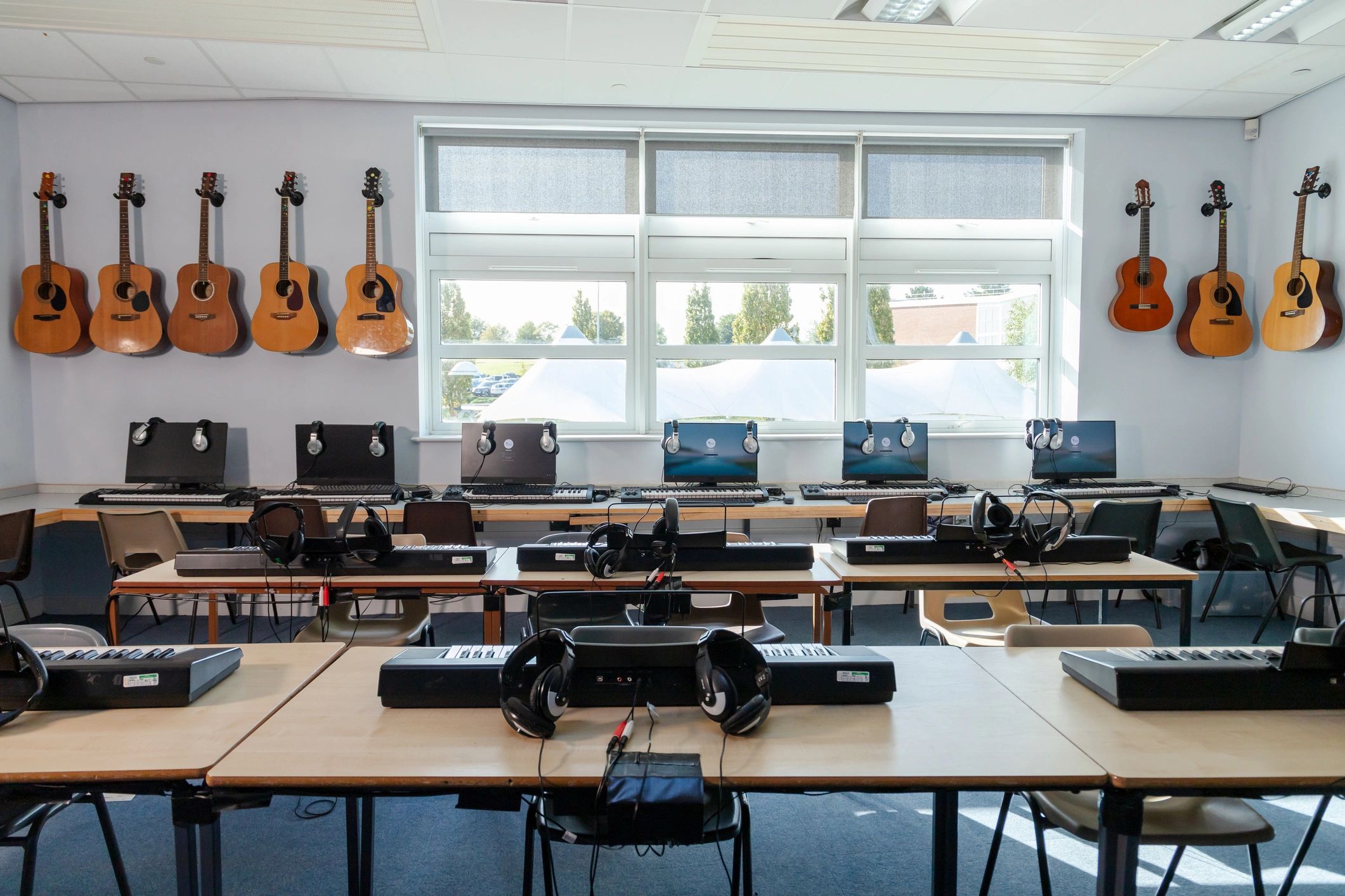 Modern music classroom with instruments and computers