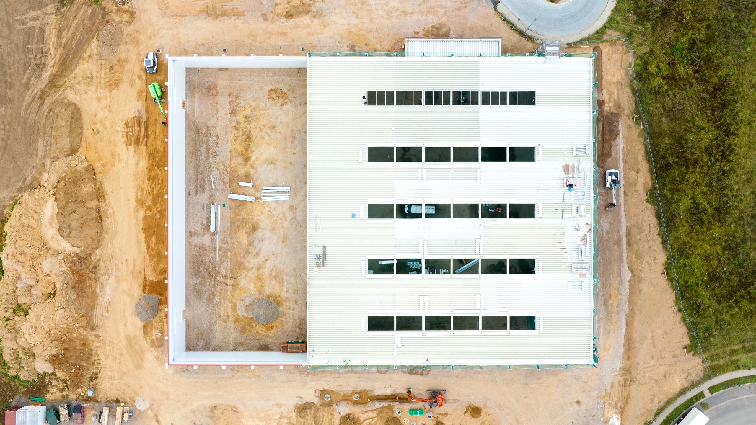 Single-story modular container office cabins at an active construction site